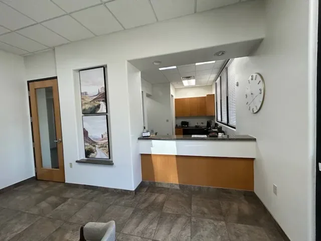 Reception counter and hallway inside Desert Willow Dental