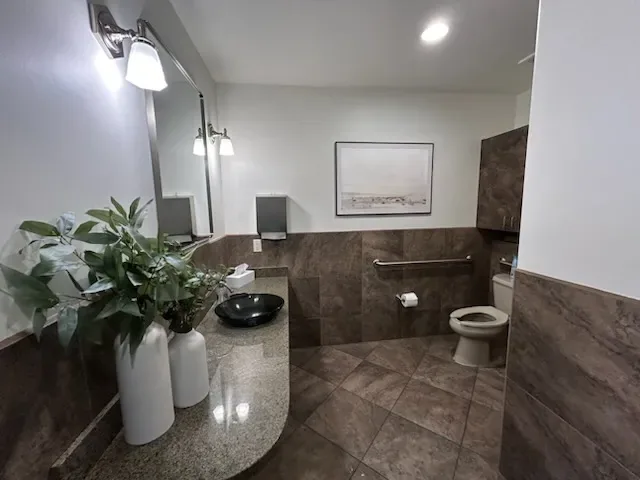 Restroom vanity and potted plant at Desert Willow Dental