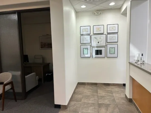 Office hallway with framed artwork and reception cabinetry