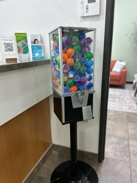 Capsule toy machine beside the reception counter and patient information display