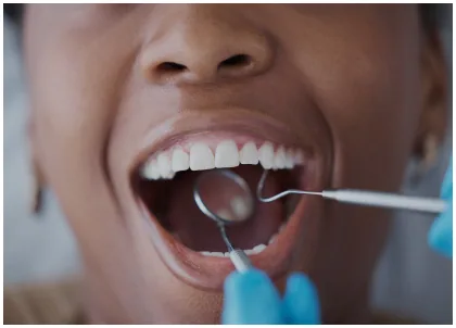 Dental professional examining a patient's teeth