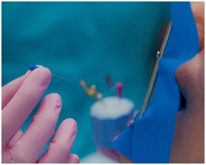 Dental professional treating a patient's tooth
